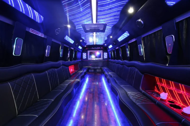 a big party bus fill ed with comfortable seats and shiny bright floor for dancing and having fun