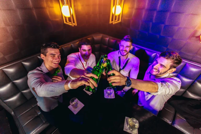 Group of young men toasting at a nightclub